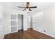 This bedroom features hardwood floors, a ceiling fan, and a closet at 974 Shirley Se St, Smyrna, GA 30082