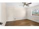 This bedroom features hardwood floors, large windows, and a ceiling fan at 974 Shirley Se St, Smyrna, GA 30082