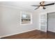 This bedroom features hardwood floors, a ceiling fan, and a closet at 974 Shirley Se St, Smyrna, GA 30082