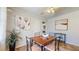 Cozy dining area featuring a wood table, ceiling fan, neutral wall paint, and two large paintings at 2640 Harrington Dr, Decatur, GA 30033