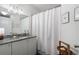 Well-lit bathroom featuring granite countertops, white cabinets, and a shower with a curtain at 390 17Th Nw St # 3055, Atlanta, GA 30363