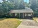 Cozy brick home features a classic design and a traditional front yard at 5278 Madison St, Forest Park, GA 30297