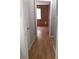 Hallway view featuring laminate flooring connecting various rooms at 5278 Madison St, Forest Park, GA 30297