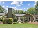 Landscaped backyard with a charming patio area, lush lawn, and mature trees offering serene outdoor living at 167 Freyer Ne Dr, Marietta, GA 30060