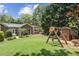 Expansive backyard featuring a lush lawn, a wooden playset, and comfortable seating for Gathering enjoyment at 167 Freyer Ne Dr, Marietta, GA 30060