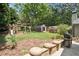 Expansive backyard featuring lush greenery, a wooden playset, and an outdoor grill for Gathering fun at 167 Freyer Ne Dr, Marietta, GA 30060