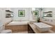 Elegant bathroom with double sink vanity, soaking tub, floating shelves and green leafy art at 167 Freyer Ne Dr, Marietta, GA 30060