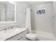 Bright bathroom featuring a shower-tub combo with updated hardware and marble countertop sink at 167 Freyer Ne Dr, Marietta, GA 30060