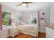 Charming bedroom featuring hardwood floors, two windows, and playful decor at 167 Freyer Ne Dr, Marietta, GA 30060