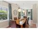 Formal dining room features decorative lighting, a wooden table, hardwood floors, and a large window at 167 Freyer Ne Dr, Marietta, GA 30060