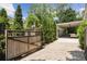 Gated driveway leading to a covered parking area surrounded by lush landscaping providing privacy and elegance at 167 Freyer Ne Dr, Marietta, GA 30060