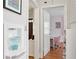 Bright hallway featuring hardwood floors, white trim, and a view into a stylishly decorated room with a desk at 167 Freyer Ne Dr, Marietta, GA 30060