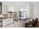 Modern kitchen with white cabinetry, stainless steel appliances, granite countertops, and a breakfast bar at 167 Freyer Ne Dr, Marietta, GA 30060