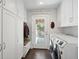 Well-organized laundry room with front loading appliances, storage cabinets and bench seat at 167 Freyer Ne Dr, Marietta, GA 30060