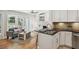Open living room with breakfast bar offers views of a cozy seating area with a sofa and lots of natural light at 167 Freyer Ne Dr, Marietta, GA 30060