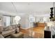 Open-concept living room with hardwood floors, a fireplace, a comfortable sofa, and access to the kitchen at 167 Freyer Ne Dr, Marietta, GA 30060