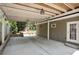 Covered patio with exposed rafters providing ample space for parking and outdoor entertaining at 167 Freyer Ne Dr, Marietta, GA 30060