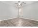 This bedroom features hardwood floors, neutral paint, a ceiling fan, and natural light from a window at 181 Paradise Pointe, Douglasville, GA 30134