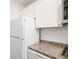 Cozy kitchen featuring white cabinets, granite countertops, and stainless steel appliances at 33 Maddox Dr, Atlanta, GA 30309