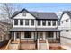 Charming two-story home with black and white trim, inviting front porch with modern railings and a well manicured yard at 971 Boulevard Se # A, Atlanta, GA 30312
