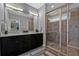 Bathroom featuring a double vanity, large mirror with modern lighting, and glass-enclosed shower at 2090 Callaway Nw Ct, Atlanta, GA 30318