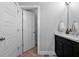 Bathroom with tiled floors, dark vanity with a white countertop, and a view into another room at 2090 Callaway Nw Ct, Atlanta, GA 30318