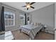 Cozy bedroom featuring two windows, a ceiling fan, neutral gray paint, and minimalist decor at 2090 Callaway Nw Ct, Atlanta, GA 30318