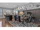 Elegant dining room featuring modern lighting, a glass table, and an open view to the kitchen at 2090 Callaway Nw Ct, Atlanta, GA 30318