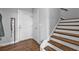 Entryway with hardwood floors, white staircase with wood trim, and a white front door at 2090 Callaway Nw Ct, Atlanta, GA 30318