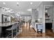 Bright kitchen with a large granite island, modern lighting, seating, and hardwood floors that continue into the living area at 2090 Callaway Nw Ct, Atlanta, GA 30318