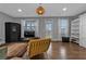 Living room with hardwood floors, a modern light fixture, and large windows for natural light at 2090 Callaway Nw Ct, Atlanta, GA 30318