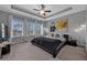 Cozy main bedroom with tray ceilings, carpeted floors, neutral walls, and bright natural light at 2090 Callaway Nw Ct, Atlanta, GA 30318