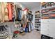 Organized walk-in closet with shelving and hanging rods for clothes and shoes at 2090 Callaway Nw Ct, Atlanta, GA 30318