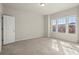 Bright and airy bedroom with neutral carpet and large windows overlooking the neighborhood at 2569 Village Park Bnd, Duluth, GA 30096