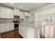 Well-lit kitchen with stainless steel appliances, granite countertops, and hardwood floors at 2569 Village Park Bnd, Duluth, GA 30096