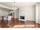 Open-concept living room with fireplace flowing into the kitchen and dining area at 2569 Village Park Bnd, Duluth, GA 30096