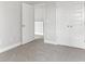 Bedroom featuring double-door closet, neutral walls, plush carpeting, and adjacent bathroom at 3787 Lockaby Way, Lawrenceville, GA 30044