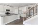 Well-designed kitchen with granite counters, stainless appliances, and white cabinetry at 3787 Lockaby Way, Lawrenceville, GA 30044