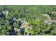 Aerial view of property nestled in a neighborhood with mature trees at 5760 Windjammer Pt, Cumming, GA 30041