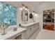 Bathroom featuring double vanity, shiplap walls, and marble countertops at 5760 Windjammer Pt, Cumming, GA 30041