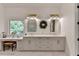 Bathroom featuring double vanity, shiplap walls, and marble countertops at 5760 Windjammer Pt, Cumming, GA 30041