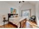 A bedroom featuring a high ceiling, hardwood floors, and a large window at 5760 Windjammer Pt, Cumming, GA 30041