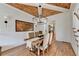 The elegant dining room features a coffered wood ceiling, shiplap walls, and hardwood floors at 5760 Windjammer Pt, Cumming, GA 30041