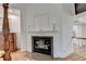 Bright room featuring a fireplace with decorative mantel and granite hearth at 5760 Windjammer Pt, Cumming, GA 30041