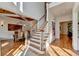 Elegant foyer featuring a staircase, wood floors, shiplap walls, and a rustic wooden ceiling at 5760 Windjammer Pt, Cumming, GA 30041