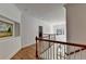 Bright hallway with hardwood floors, white walls, and a decorative chandelier hanging over the foyer at 5760 Windjammer Pt, Cumming, GA 30041