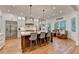 Bright kitchen with stainless steel appliances, a large island, pendant lights, and hardwood floors at 5760 Windjammer Pt, Cumming, GA 30041