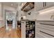 Custom kitchen featuring a pull-out drawer with organized spice rack, next to cooking area at 5760 Windjammer Pt, Cumming, GA 30041