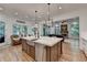 Kitchen with stainless steel appliances, island sink and pendant lights, and hardwood floors at 5760 Windjammer Pt, Cumming, GA 30041