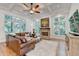 Cozy living room with brick fireplace, coffered ceilings, and bright windows at 5760 Windjammer Pt, Cumming, GA 30041